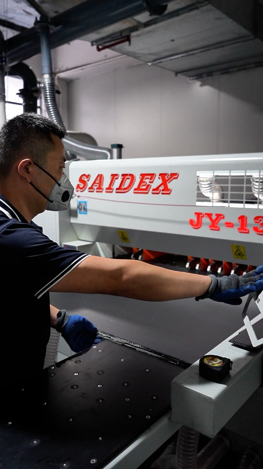 Worker operating carbon fiber production equipment